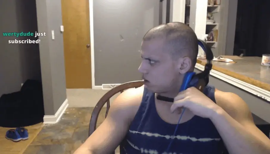 Person with a headset looks to the side while sitting in a room.