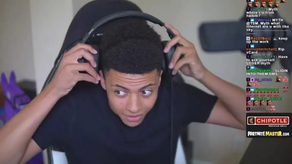 A person adjusts their headphones while streaming a gaming session, with chat messages on the right side of the screen.