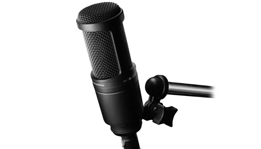 Black condenser microphone on a boom arm, positioned against a white background.
