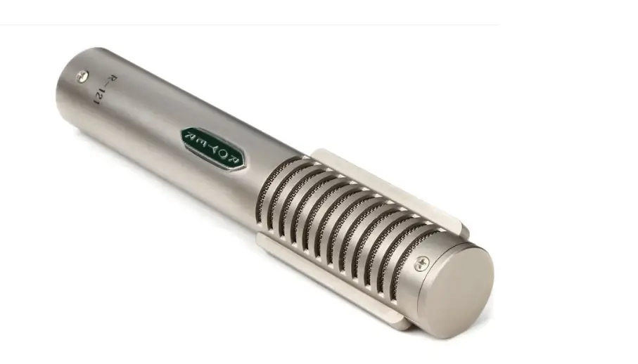 Silver cylindrical microphone with grille detailing and engraved text, angled on a white background.