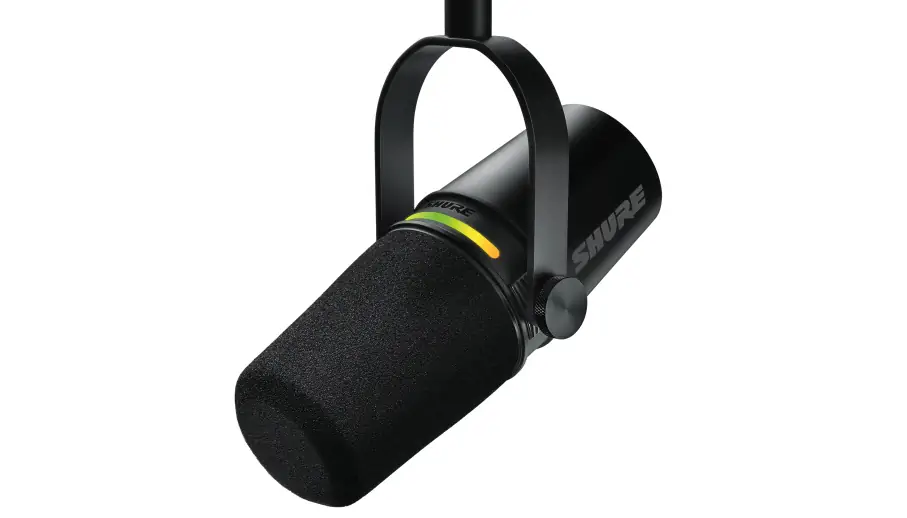 Black Shure microphone with foam head, mounted horizontally, featuring brand logo and colored ring indicator.